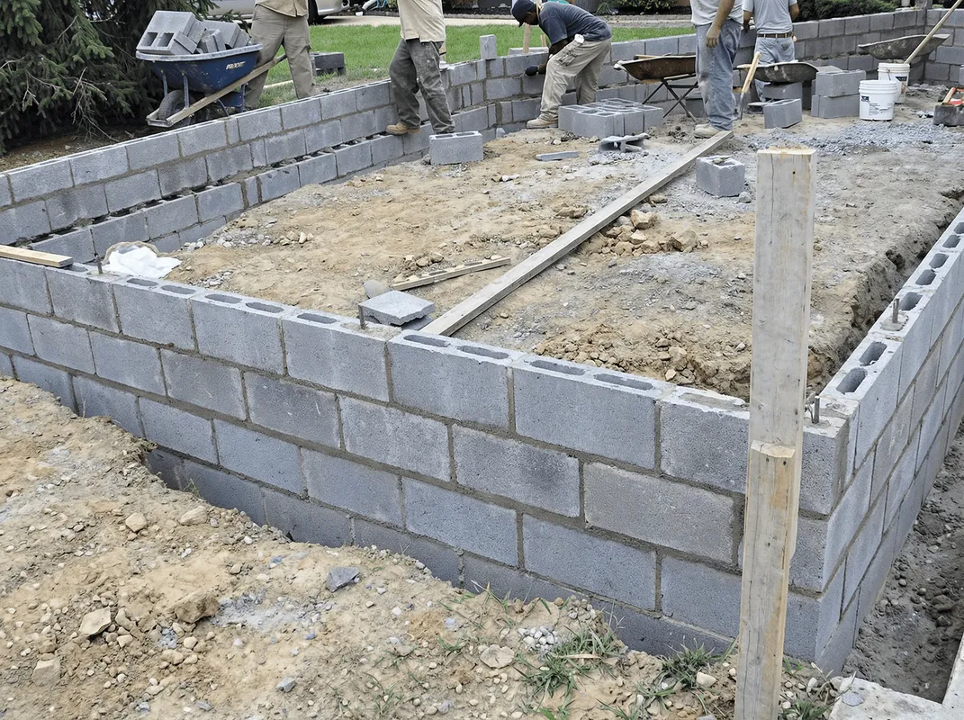 Professionals building a foundation with blocks in Nashua, NH
